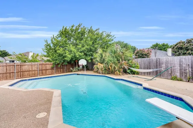 a view of a backyard with swimming pool