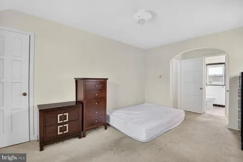 a view of a hallway with furniture and a livingroom