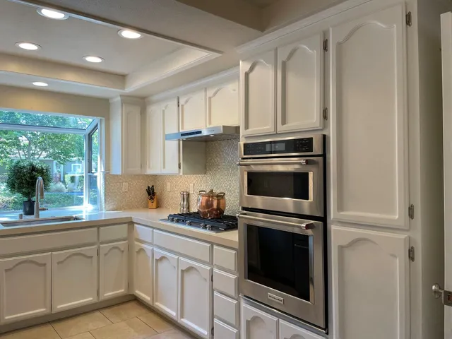 a kitchen with cabinets stainless steel appliances and counter space