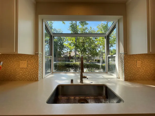 a view of a sink and floor to ceiling window