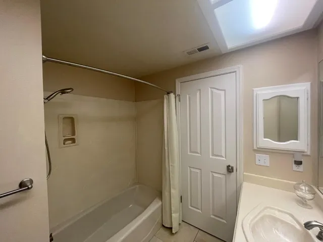 a bathroom with a granite countertop sink a toilet and shower