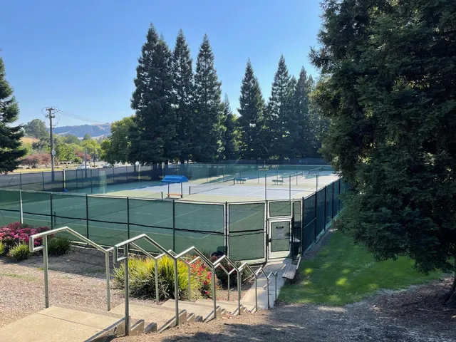 a view of a patio with a table chairs and a yard