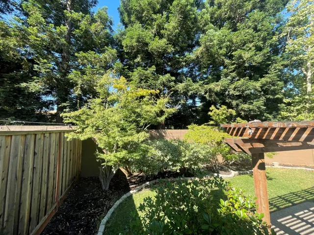 a view of a patio with table and chairs potted plants with wooden floor