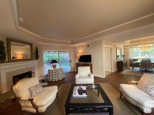 a living room with furniture fireplace and a flat screen tv