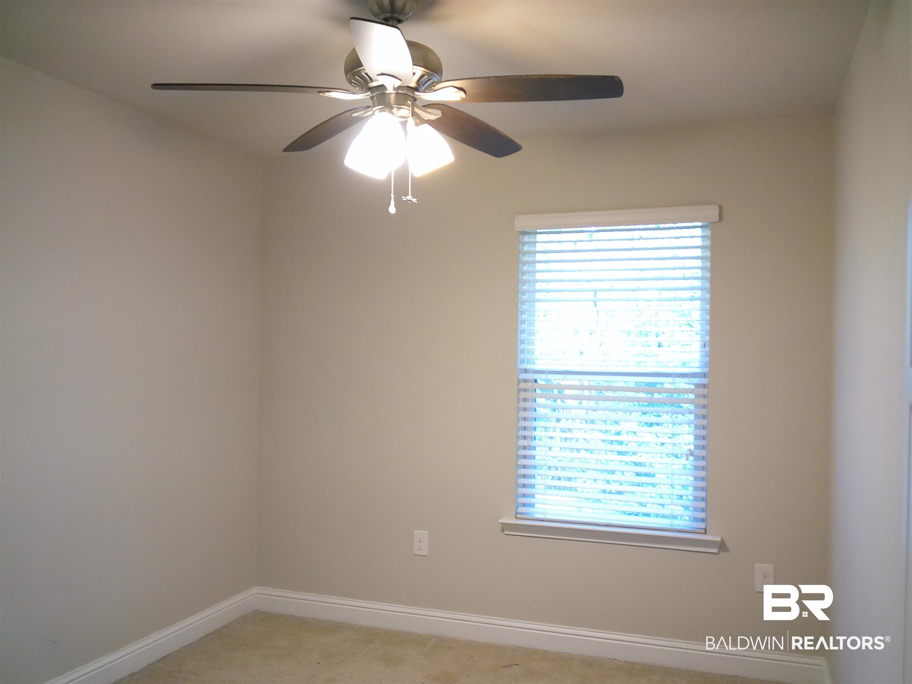 25806 Pollard Road, Unit 23 Daphne, AL 36526 - Photo 9 of 16 Spare room featuring ceiling fan and light colored carpet