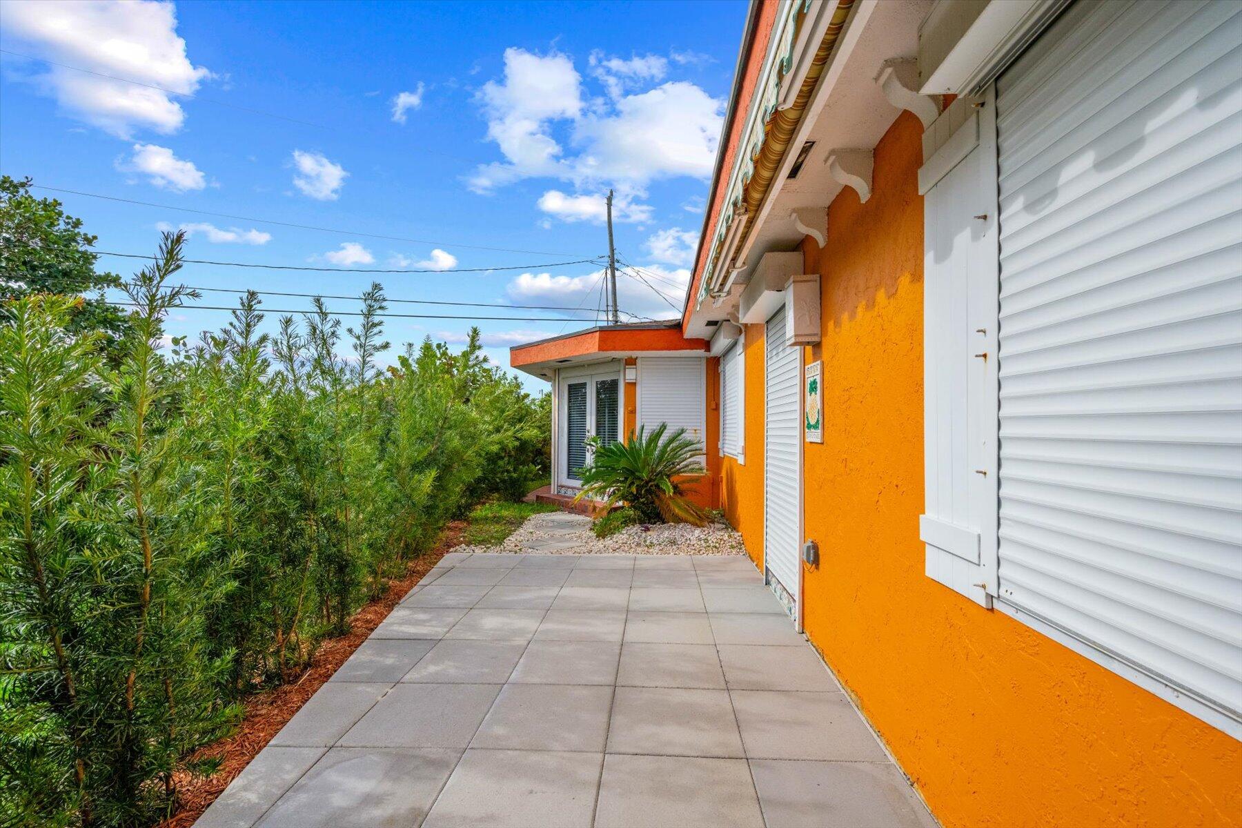 390 Neptune Road Juno Beach, FL 33408 - Photo 25 of 32 Stone walkway to front entrance