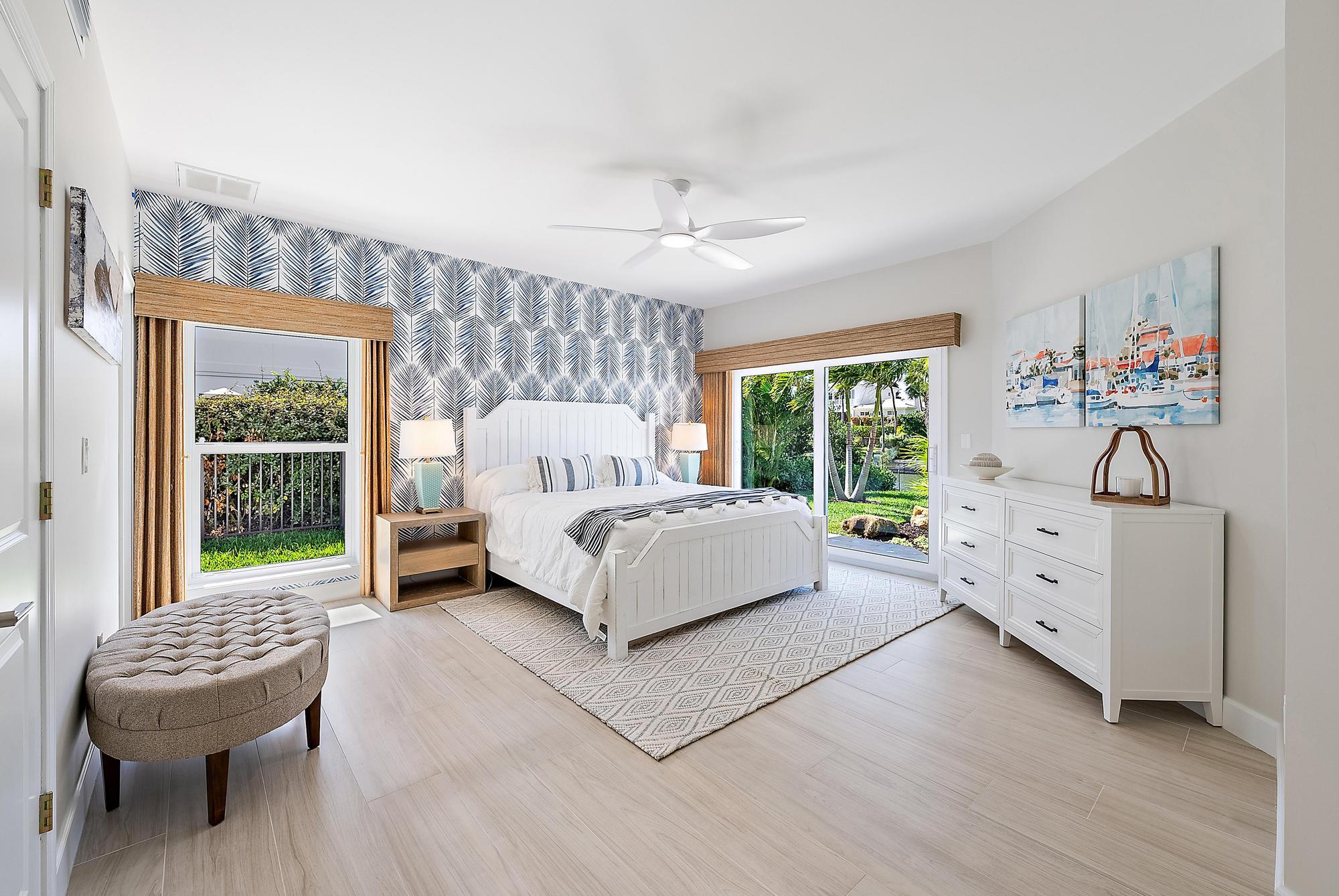 19 Island Road Sewall's Point, FL 34996 - Photo 25 of 50 a bedroom with a bed and a large window
