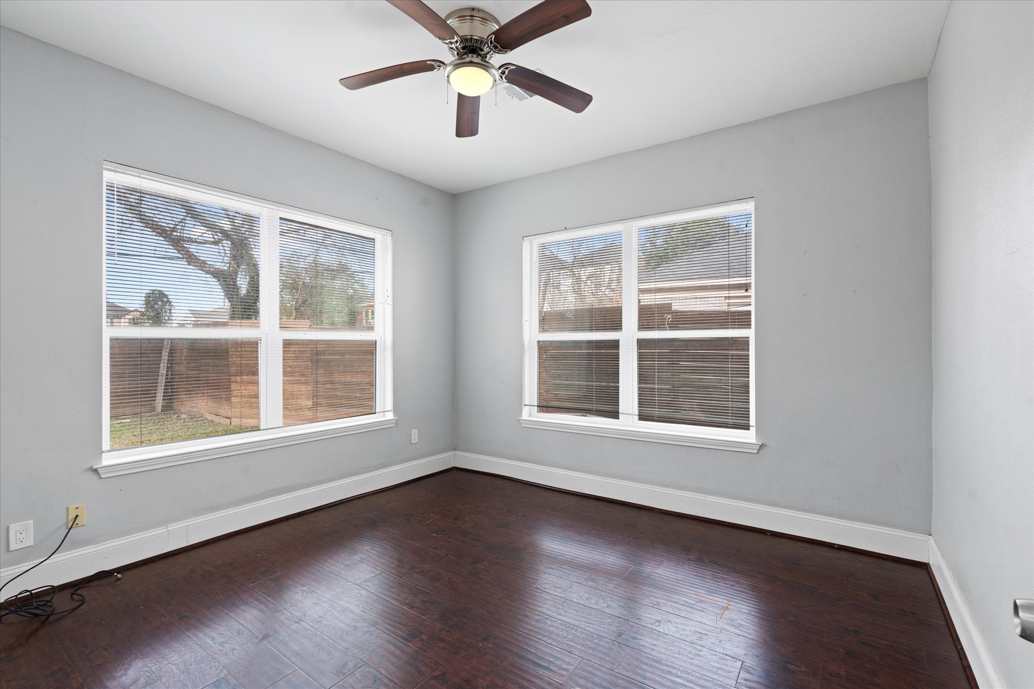2614 Isabella Street Houston, TX 77004 - Photo 7 of 10 an empty room with wooden floor chandelier and windows