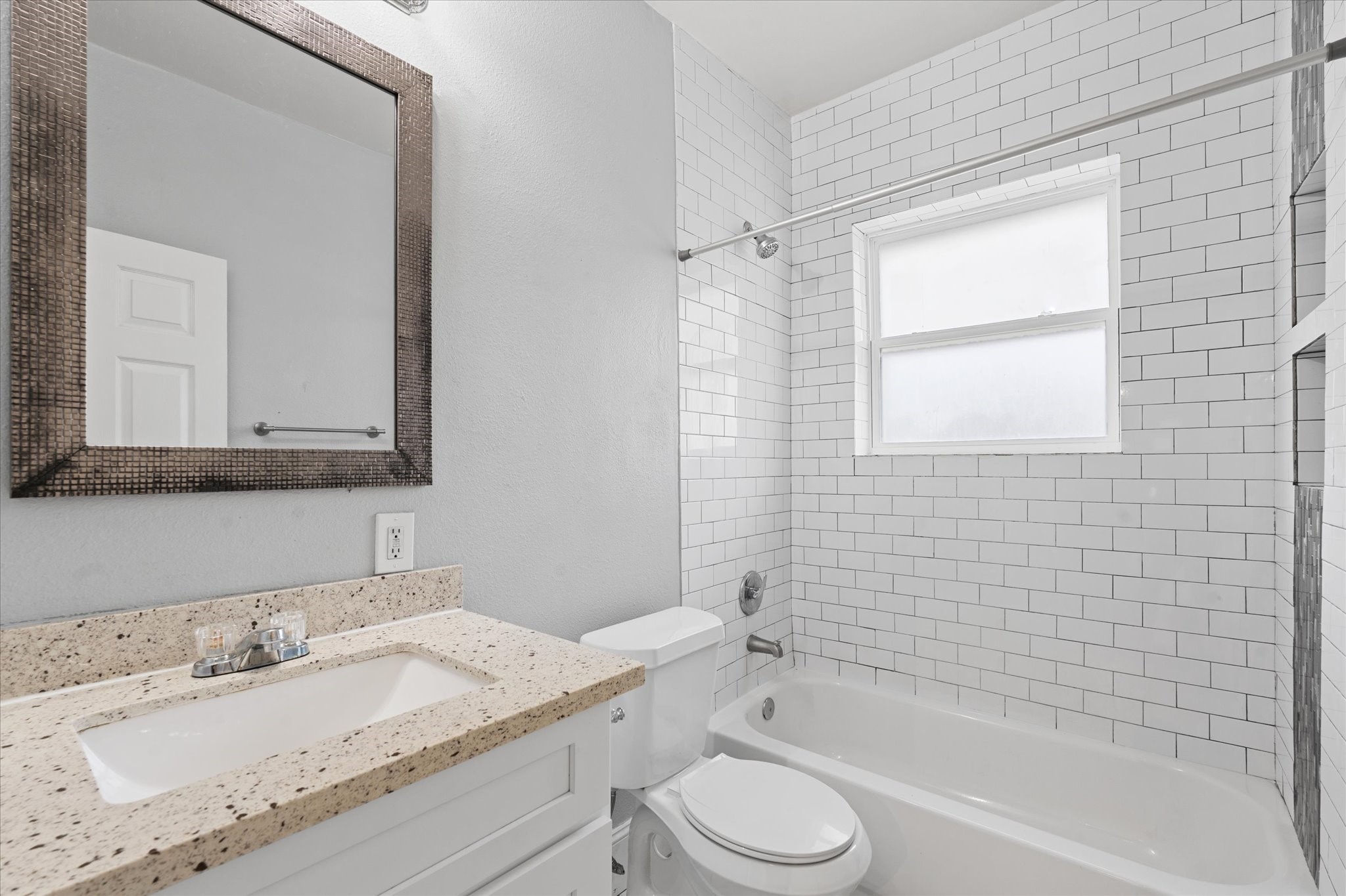 2614 Isabella Street Houston, TX 77004 - Photo 8 of 10 a bathroom with a granite countertop sink toilet a mirror and bathtub
