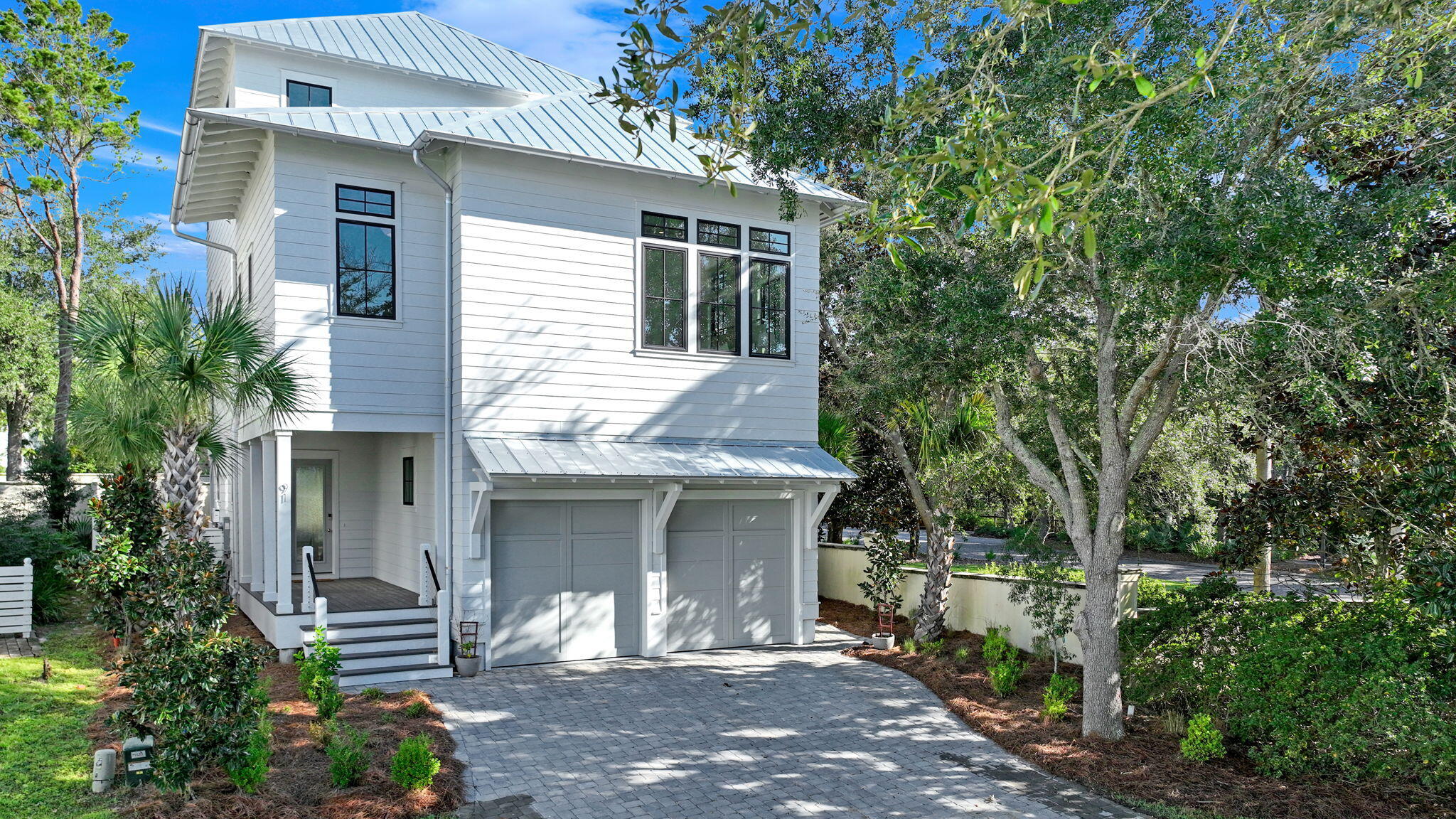 91 Grande Pointe Drive Inlet Beach, FL 32461 - Photo 2 of 51 a front view of a house with a garden