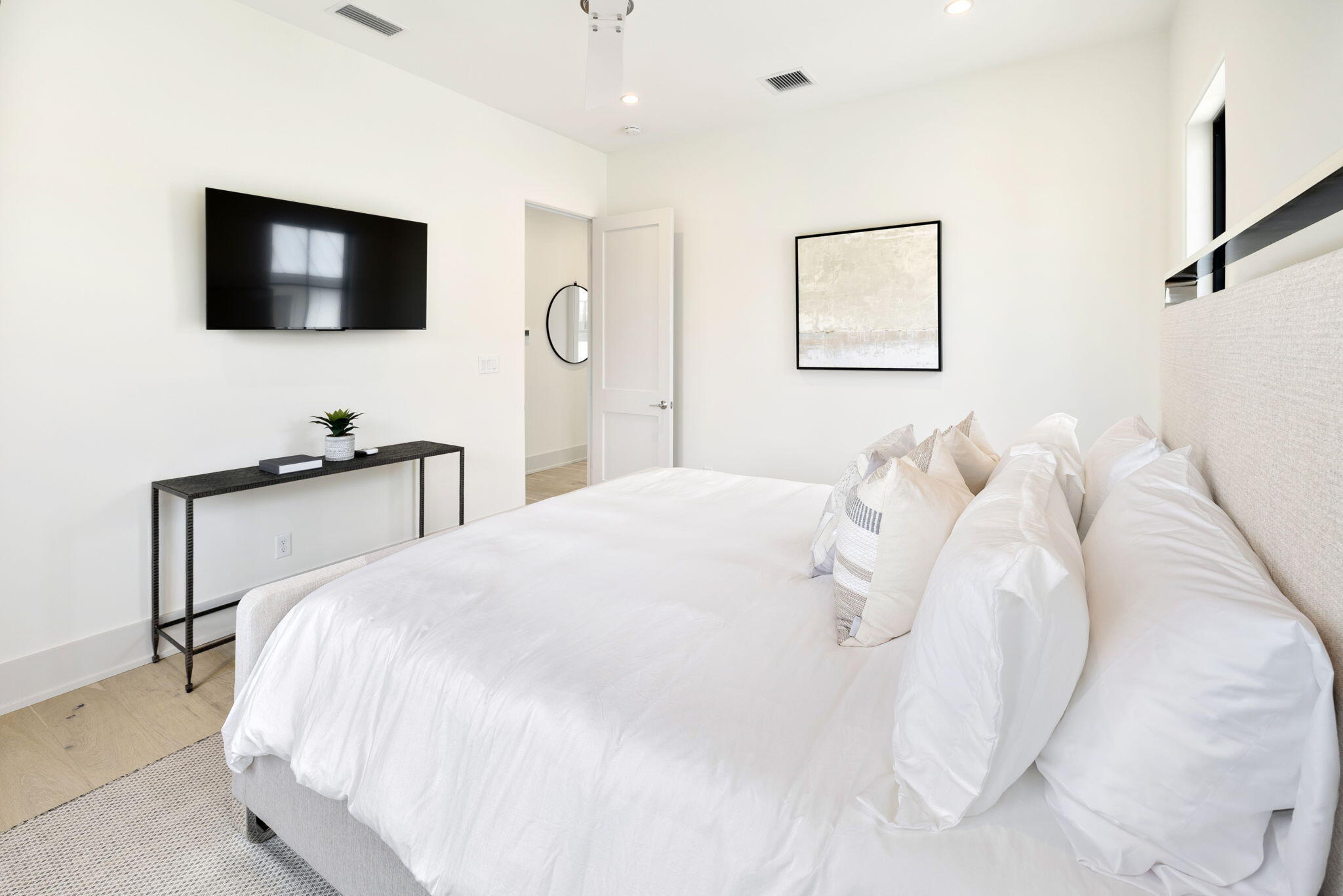 91 Grande Pointe Drive Inlet Beach, FL 32461 - Photo 36 of 51 a bedroom with a bed and a flat tv screen on wall