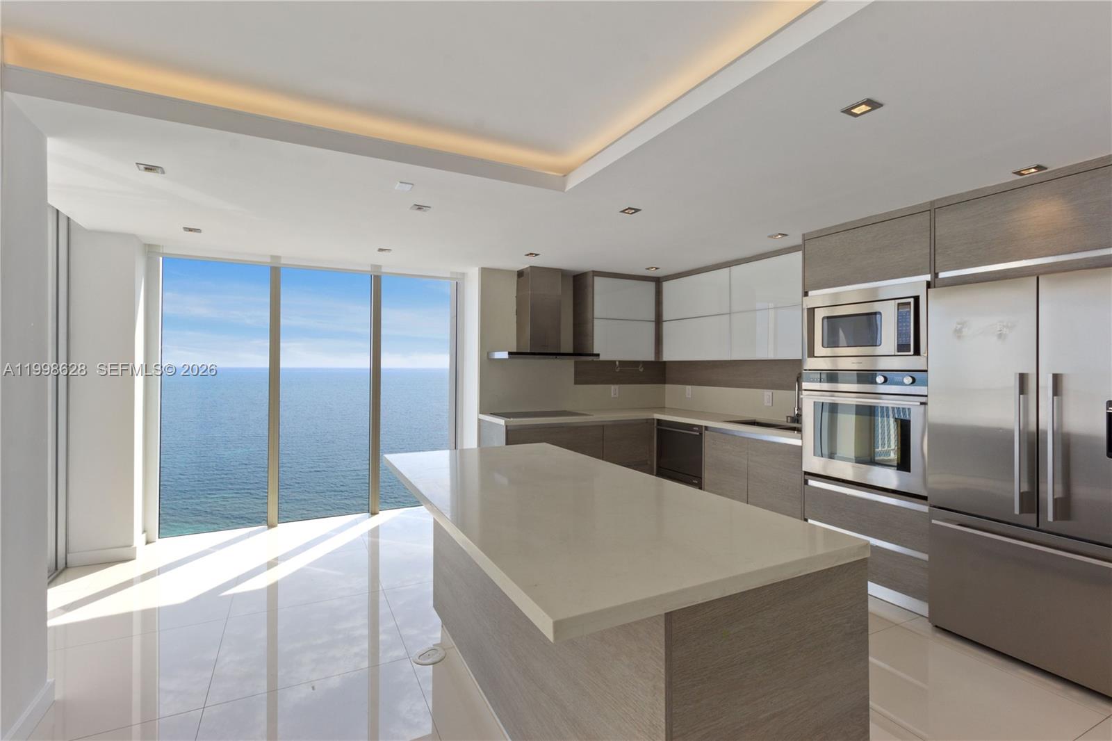 881 Ocean Drive, Unit 18F Key Biscayne, FL 33149 - Photo 3 of 12 a kitchen with granite countertop a refrigerator and a sink