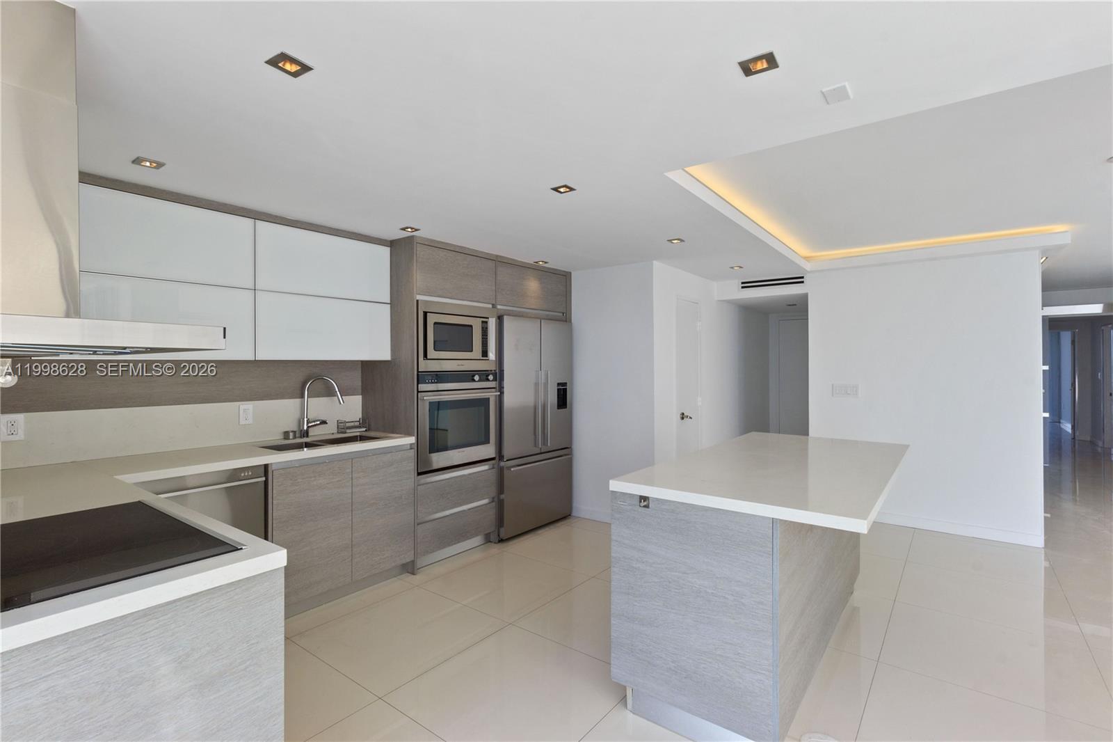 881 Ocean Drive, Unit 18F Key Biscayne, FL 33149 - Photo 4 of 12 a kitchen with stainless steel appliances a refrigerator and a stove