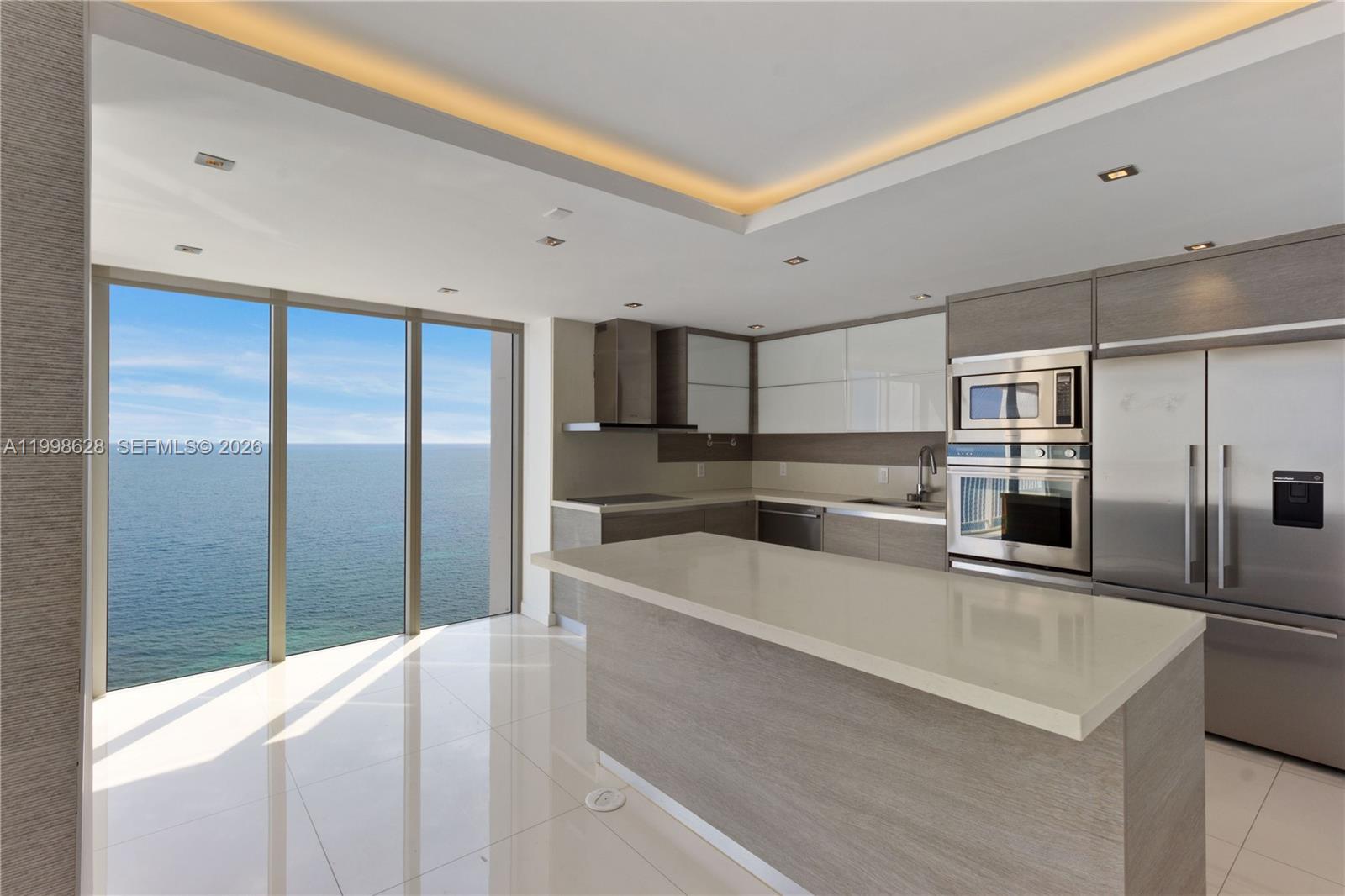 881 Ocean Drive, Unit 18F Key Biscayne, FL 33149 - Photo 5 of 12 a large kitchen with stainless steel appliances a large counter top
