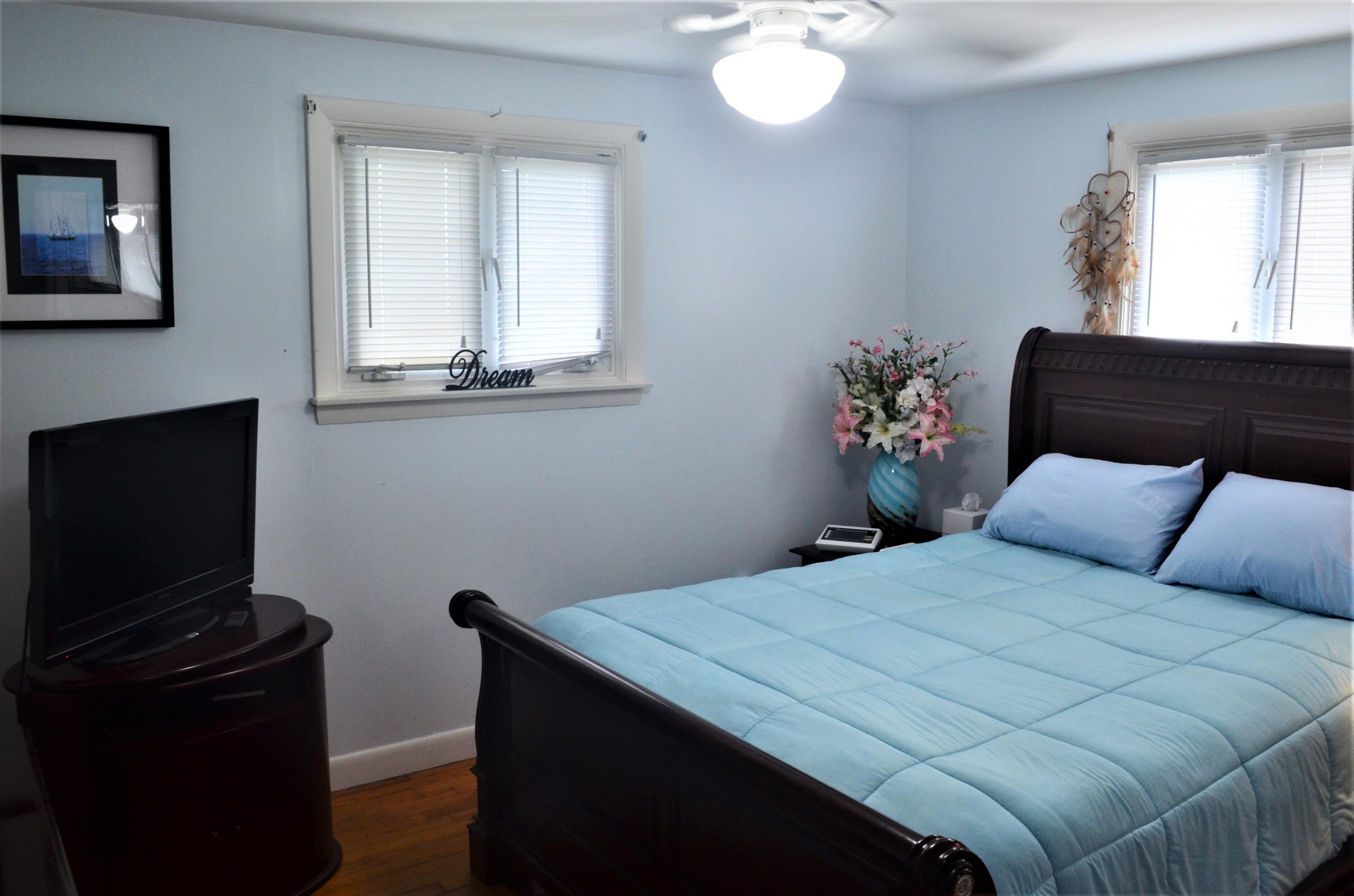 3 Wenonah Road Buzzards Bay, MA 02532 - Photo 14 of 25 a bedroom with a bed and a fireplace