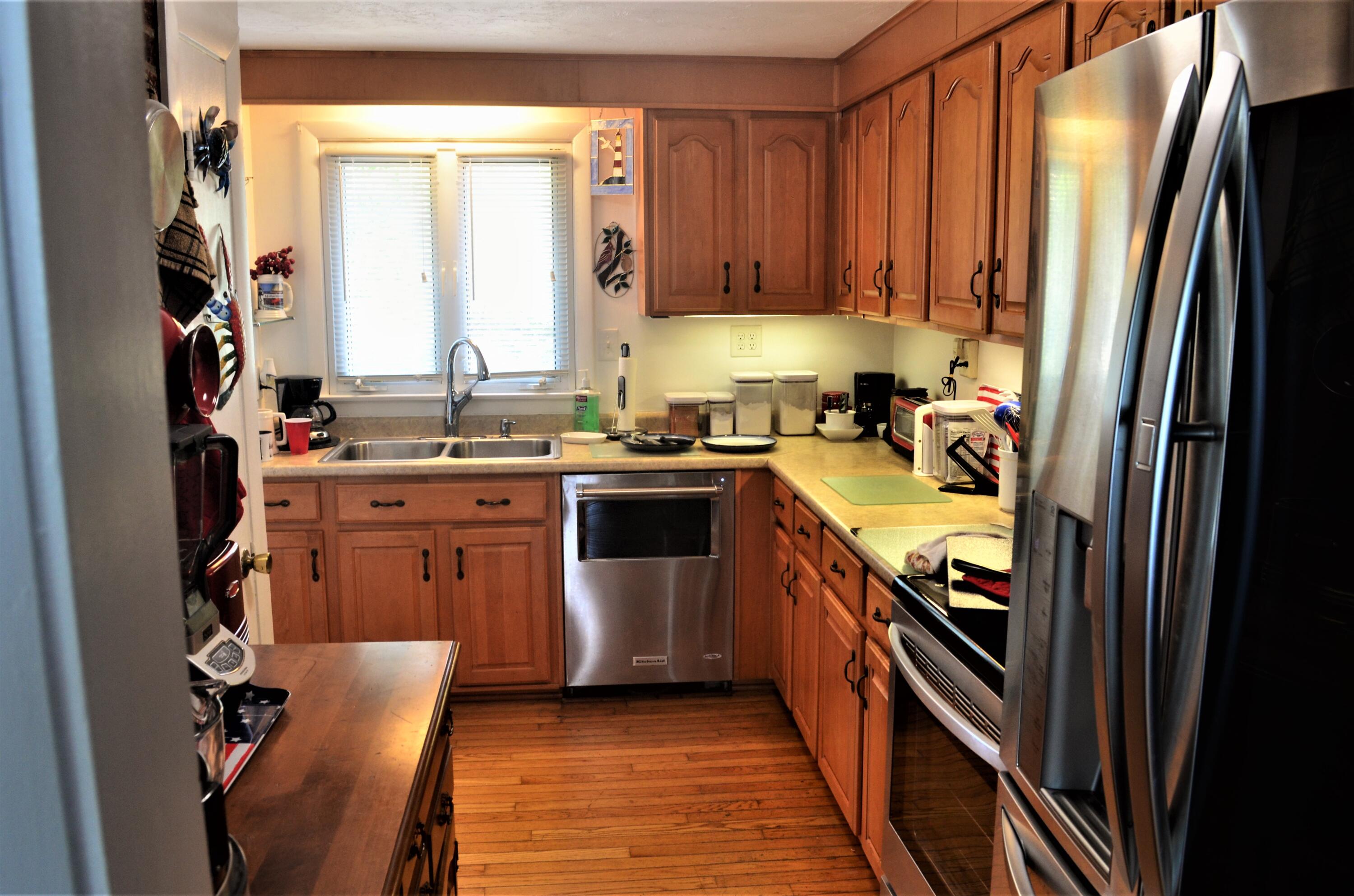 3 Wenonah Road Buzzards Bay, MA 02532 - Photo 9 of 25 a kitchen with stainless steel appliances a sink a stove a refrigerator and cabinets