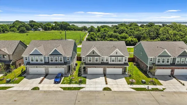 an aerial view of a house with swimming pool and patio