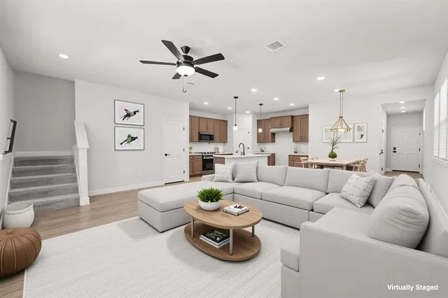 a large kitchen with stainless steel appliances granite countertop a sink a stove top oven a counter space and cabinets