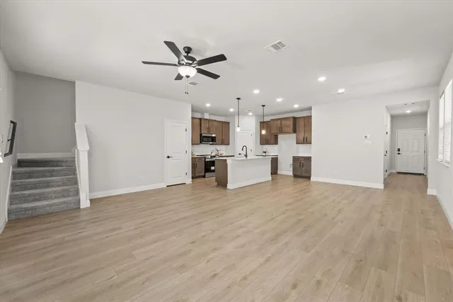 a living room with furniture and view of kitchen
