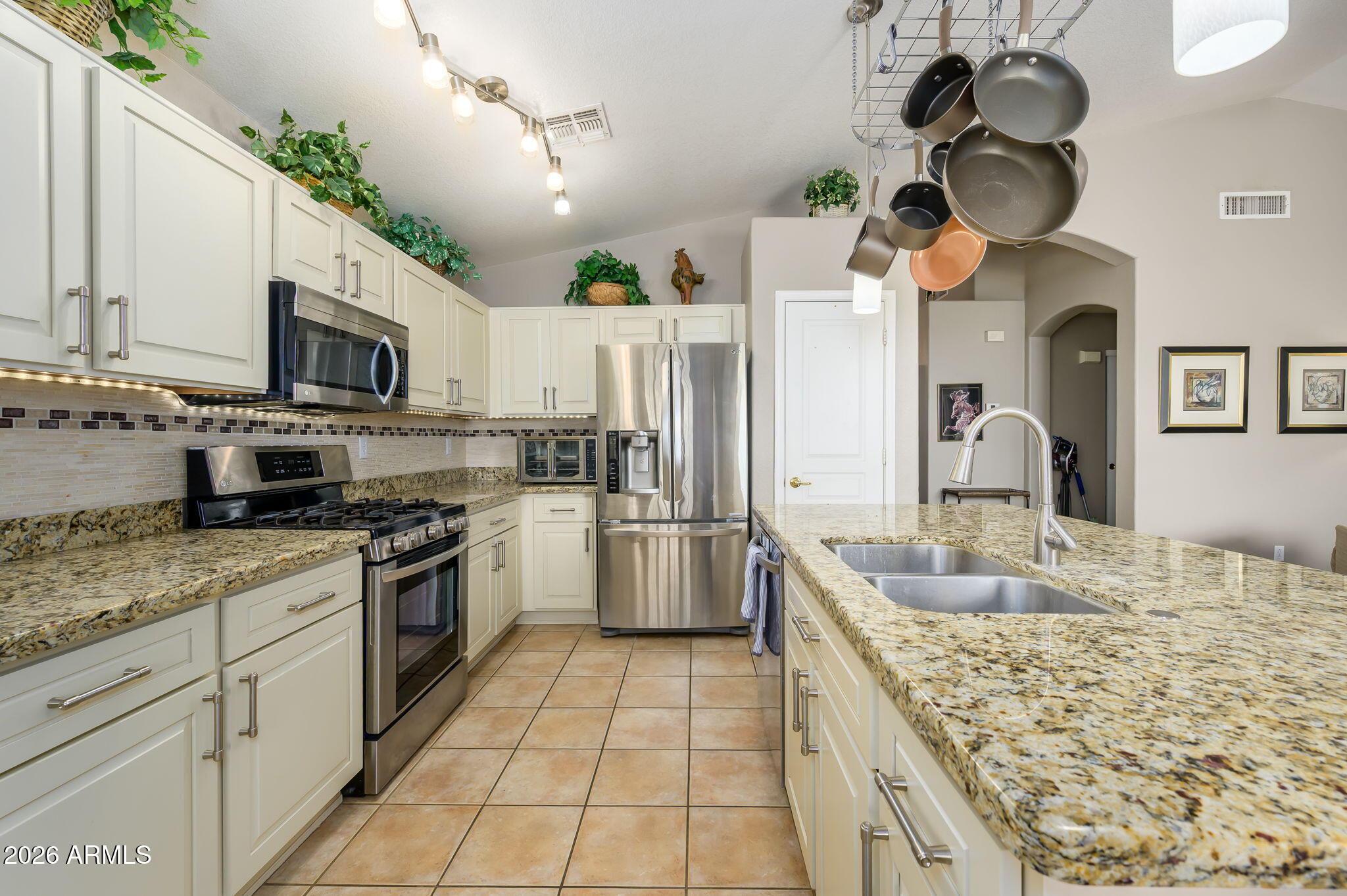 3136 East Roveen Avenue Phoenix, AZ 85032 - Photo 11 of 38 a kitchen with stainless steel appliances granite countertop a sink dishwasher stove and refrigerator with wooden floor