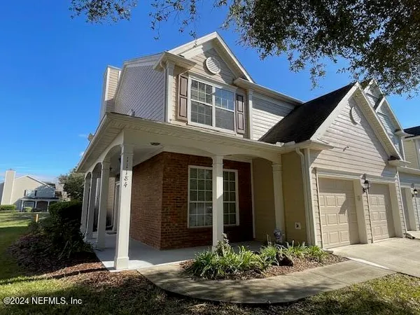 a front view of a house with a yard garage and outdoor seating