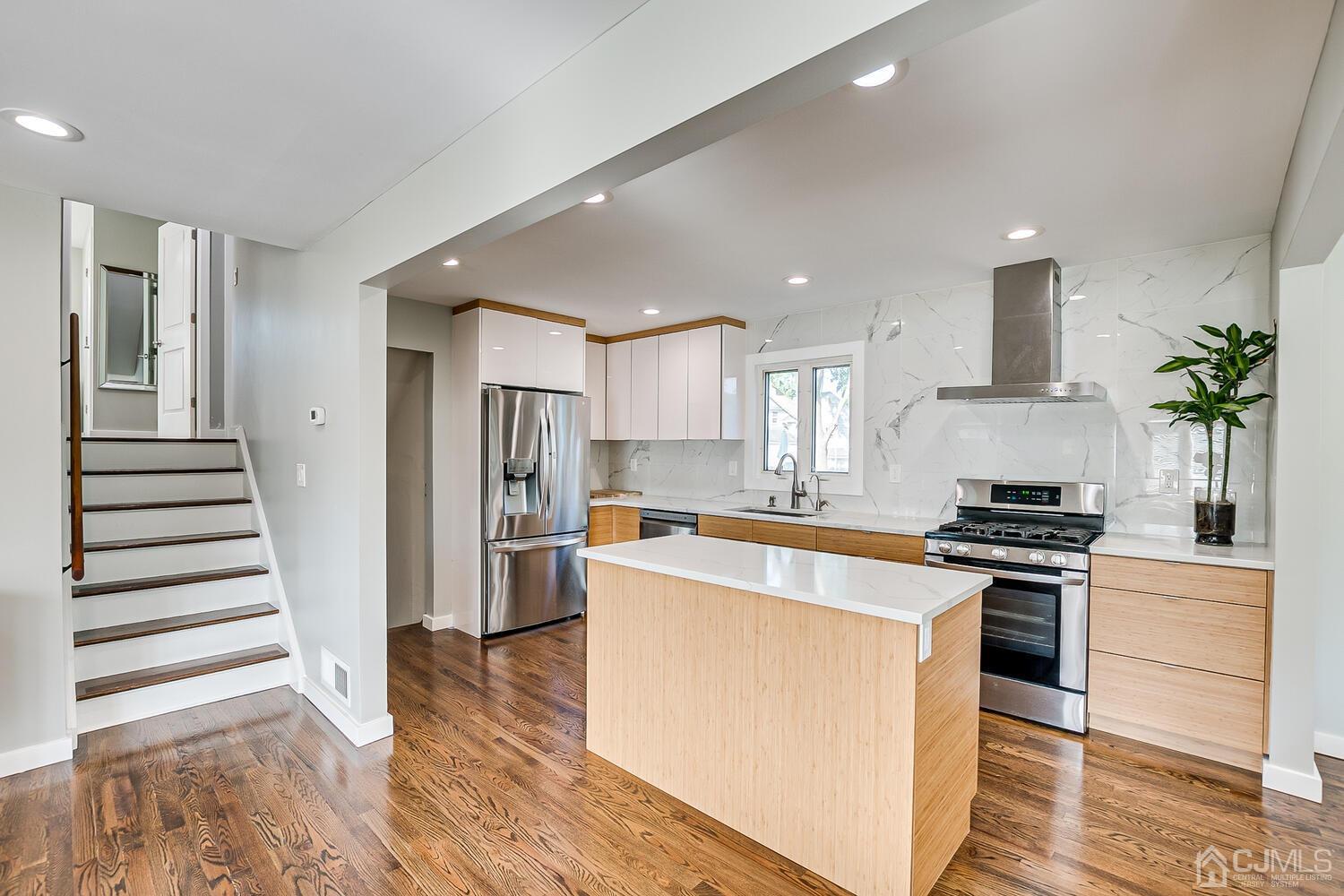 5 Leland Road Edison, NJ 08817 - Photo 11 of 48 a kitchen with stainless steel appliances white cabinets and wooden floor