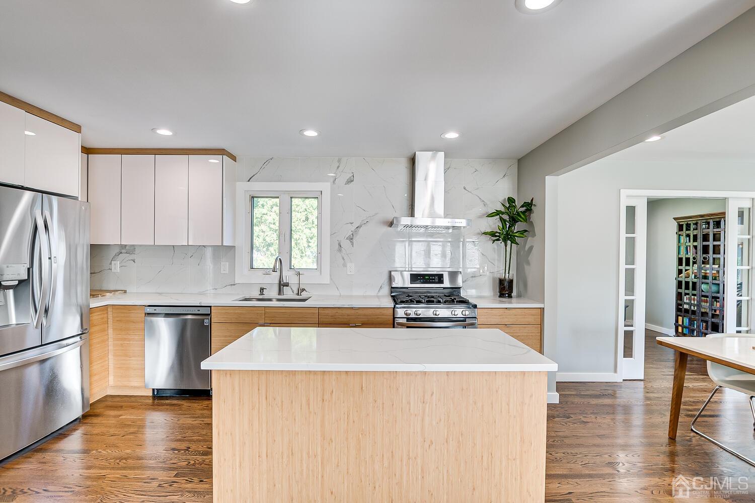 5 Leland Road Edison, NJ 08817 - Photo 16 of 48 a kitchen with sink a refrigerator and wooden floor