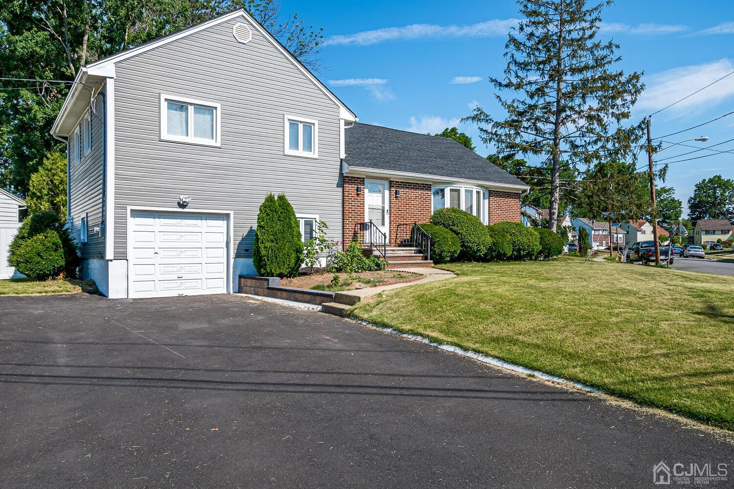 5 Leland Road Edison, NJ 08817 - Photo 5 of 48 a front view of a house with a yard and garage