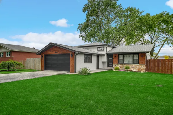 a front view of house with yard and green space