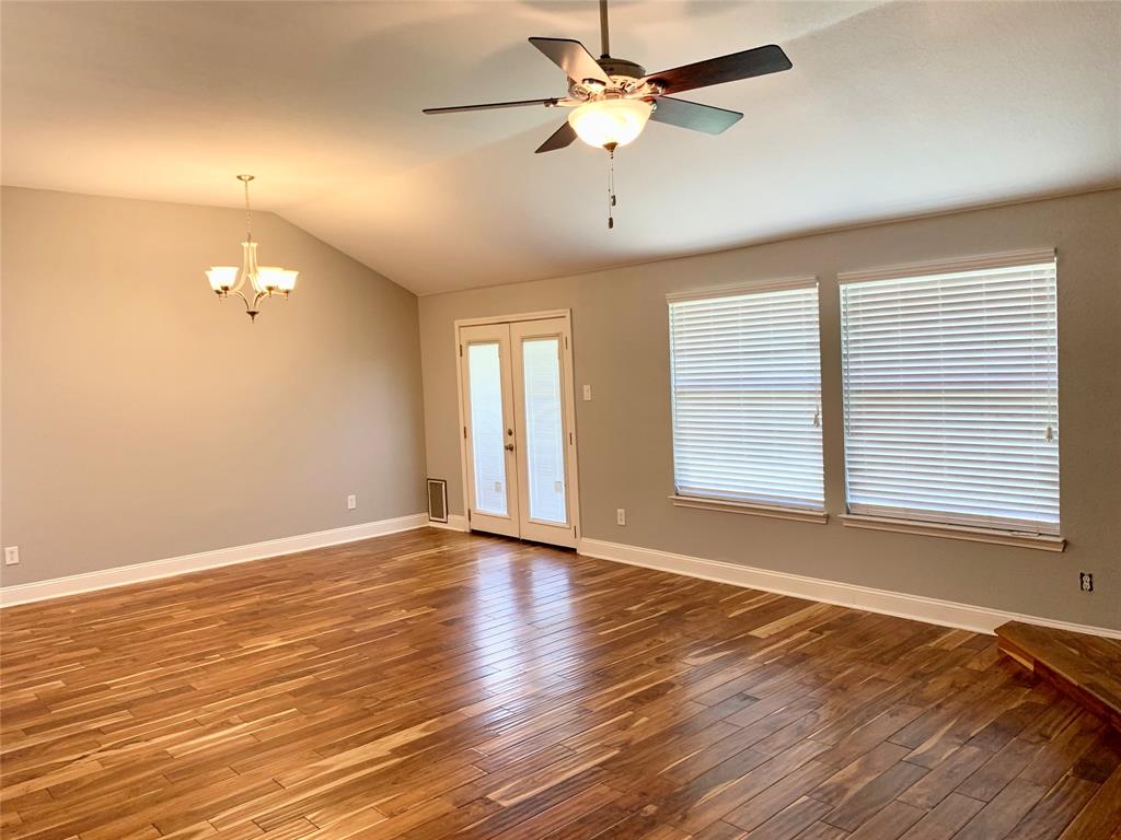 2012 Piper Drive Corinth, TX 76210 - Photo 12 of 27 an empty room with wooden floor and windows