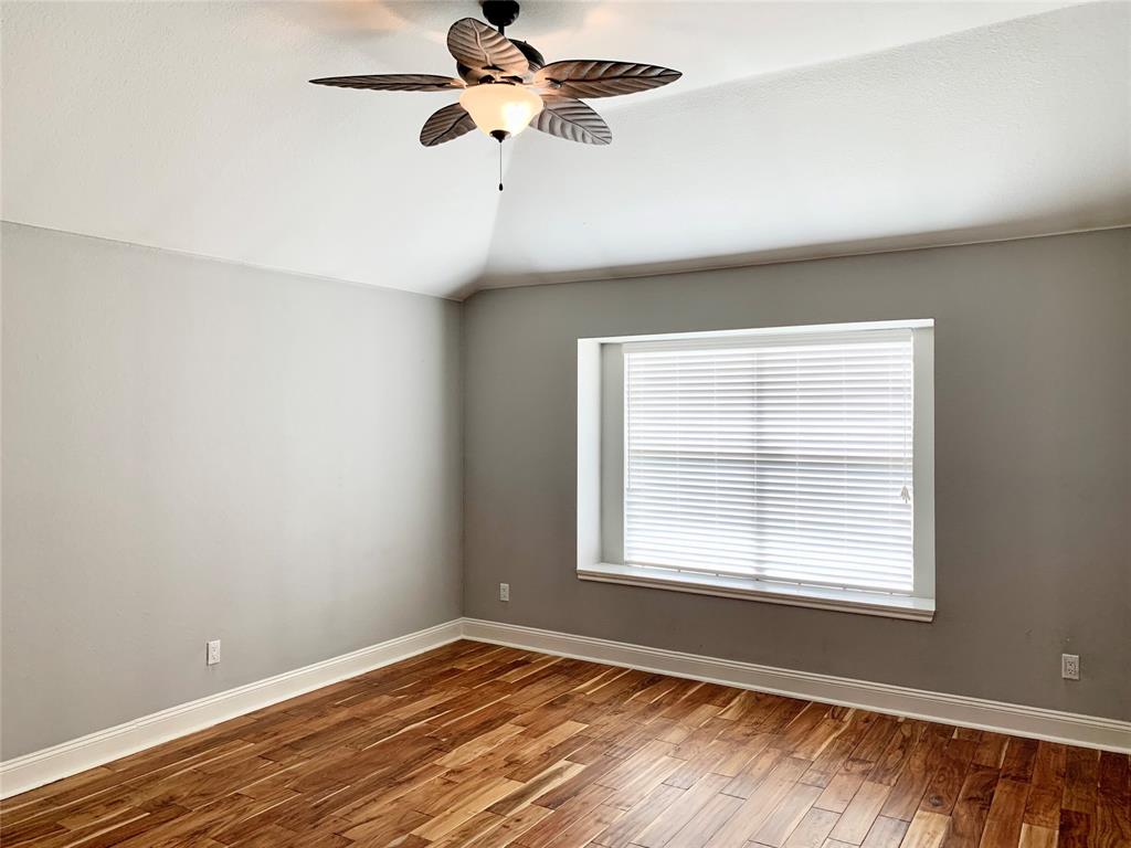 2012 Piper Drive Corinth, TX 76210 - Photo 14 of 27 a view of an empty room with wooden floor and a window