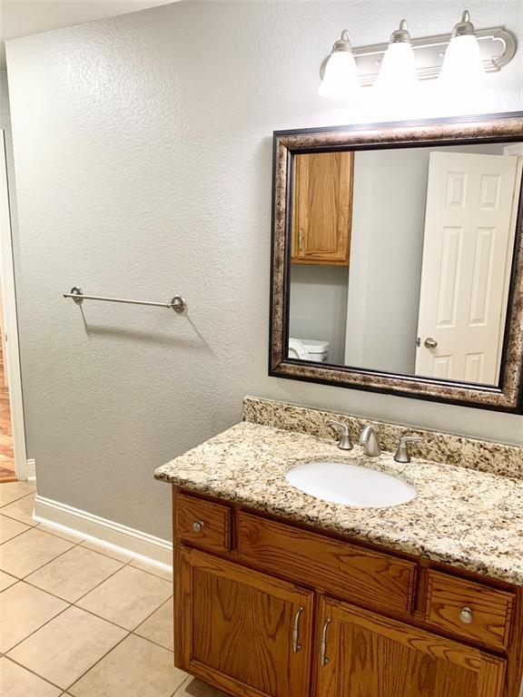 2012 Piper Drive Corinth, TX 76210 - Photo 20 of 27 a bathroom with a granite countertop sink and a mirror