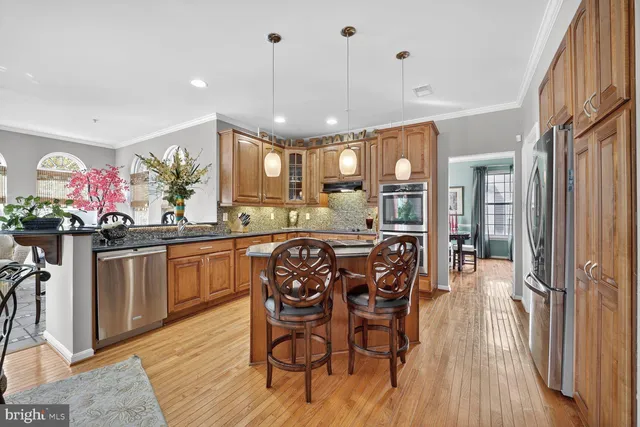 a large kitchen with a table and chairs
