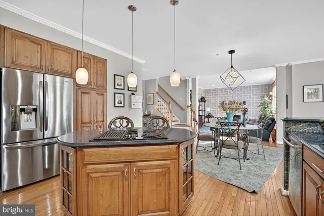 a kitchen with stainless steel appliances granite countertop a stove and refrigerator