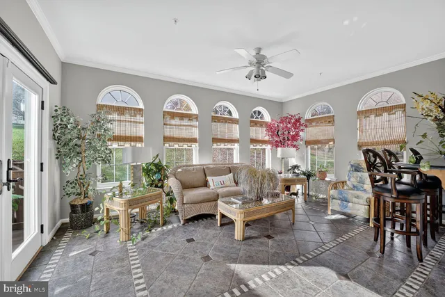 a living room with furniture a chandelier and a large window