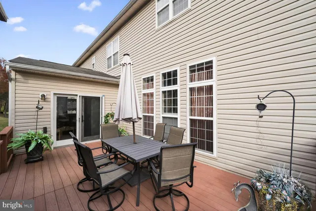 a view of a patio with table and chairs and potted plants