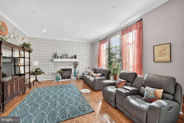 a living room with furniture large window and fireplace