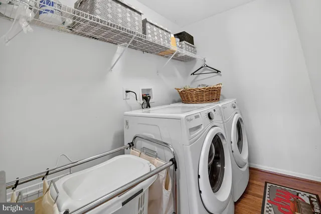 a view of a hallway with furniture and wooden floor