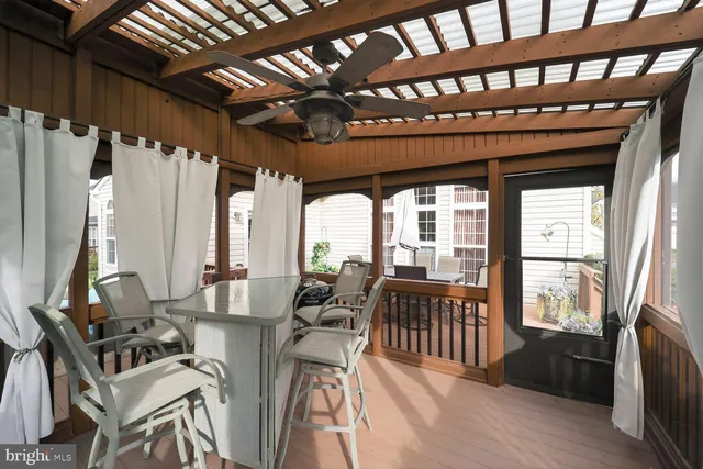 a view of a dinning table and chairs in patio of the house