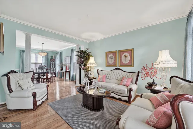 a living room with furniture and a chandelier