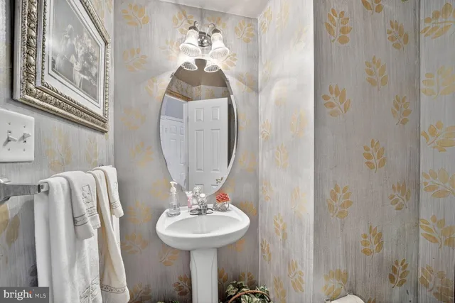 a bathroom with a sink and mirror with toilet