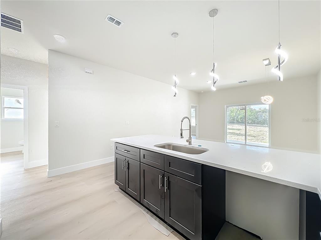 356 West 4th Street Apopka, FL 32703 - Photo 12 of 32 a kitchen with a sink and a window