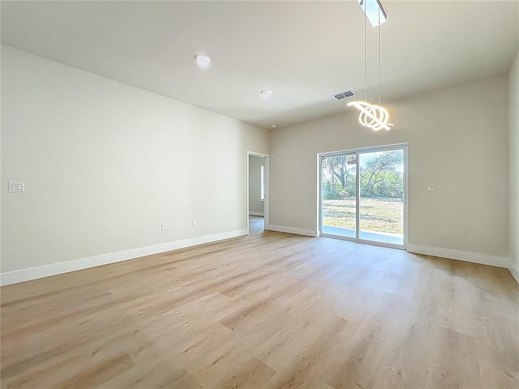 356 West 4th Street Apopka, FL 32703 - Photo 13 of 32 wooden floor in an empty room with a window