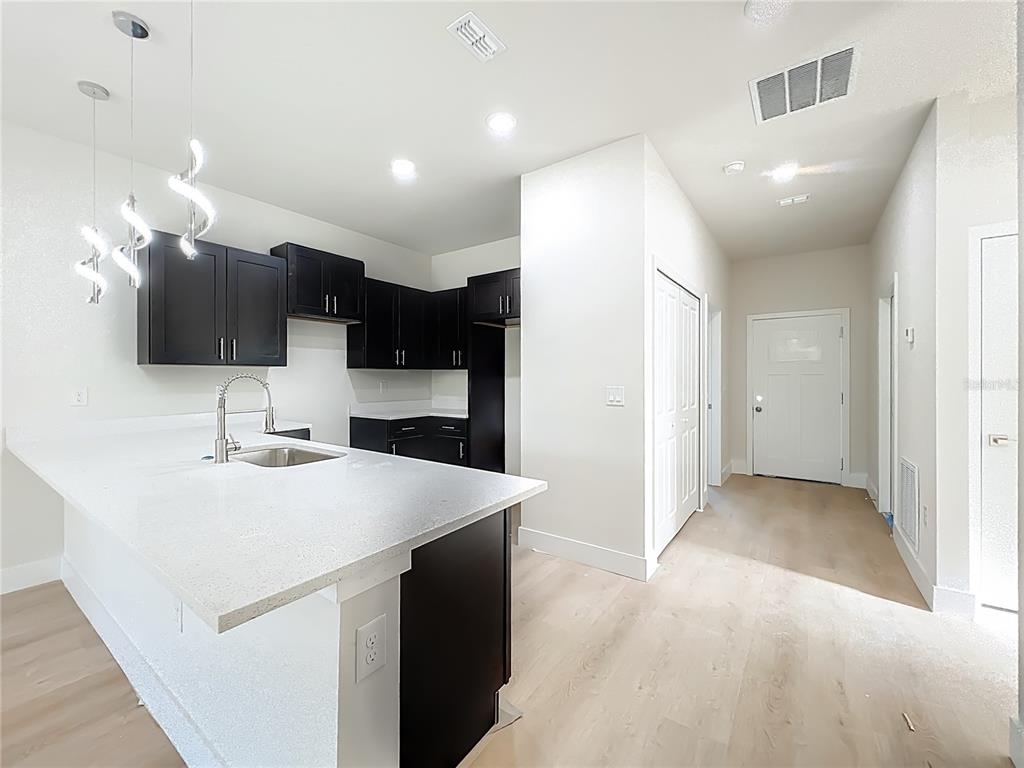 356 West 4th Street Apopka, FL 32703 - Photo 14 of 32 a view of kitchen with cabinets and wooden floor