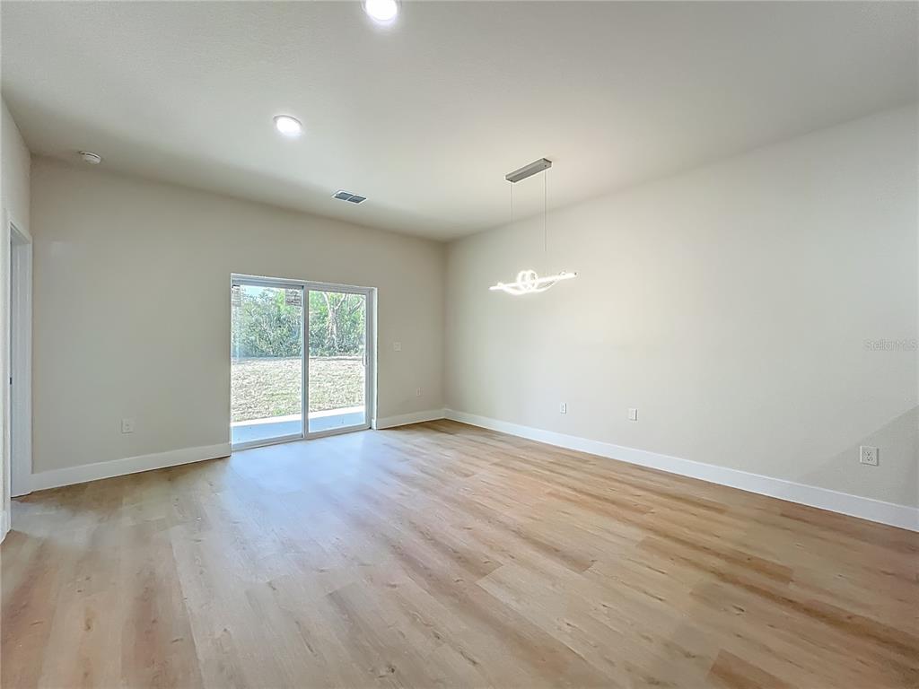 356 West 4th Street Apopka, FL 32703 - Photo 15 of 32 a view of an empty room with wooden floor and a window