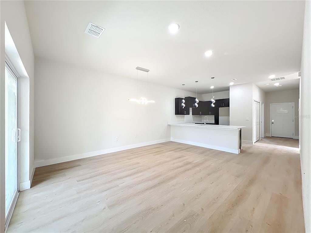 356 West 4th Street Apopka, FL 32703 - Photo 17 of 32 a view of kitchen and hall with wooden floor