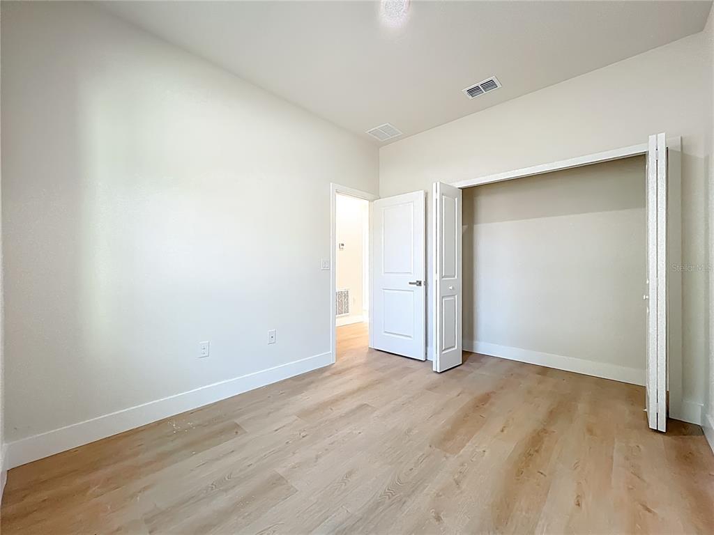 356 West 4th Street Apopka, FL 32703 - Photo 19 of 32 an empty room with wooden floor