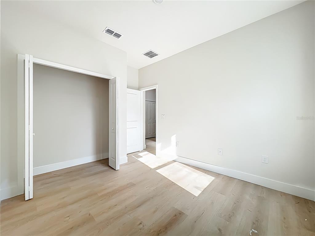 356 West 4th Street Apopka, FL 32703 - Photo 21 of 32 an empty room with wooden floor and windows