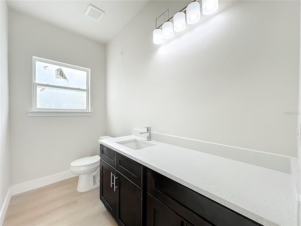 356 West 4th Street Apopka, FL 32703 - Photo 22 of 32 a bathroom with a sink a toilet and a window