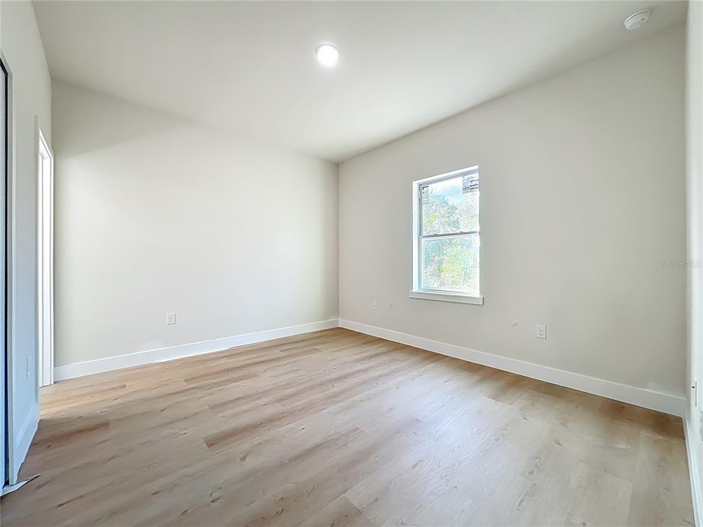 356 West 4th Street Apopka, FL 32703 - Photo 26 of 32 an empty room with wooden floor and windows